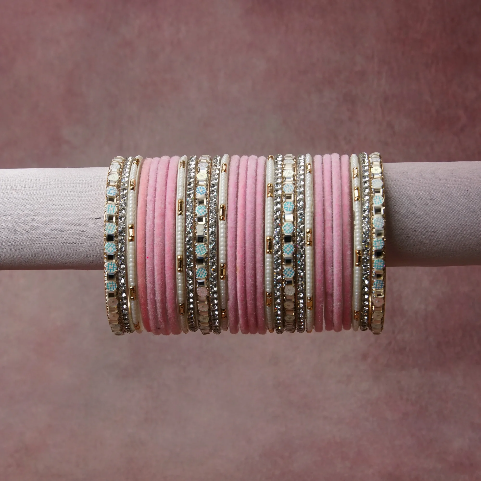 A grounding Blush Pink forms the heart of the set, while touches of Silver, Gold, Pale Aqua add charm.

A thoughtful composition of Velvet, Metal (Silver-toned, Gold-toned), Glass Rhinestones, Simulated Pearls, Glass Beads, Enamel, designed to feel complete without being heavy.
Each element layers seamlessly, creating a look that is refined, wearable and quietly striking.